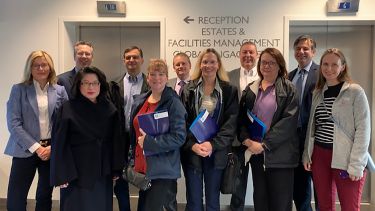 A group of AREC visitors and members stood inside the University Management School.